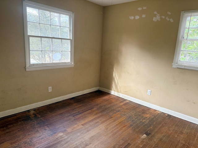 spare room featuring dark hardwood / wood-style floors