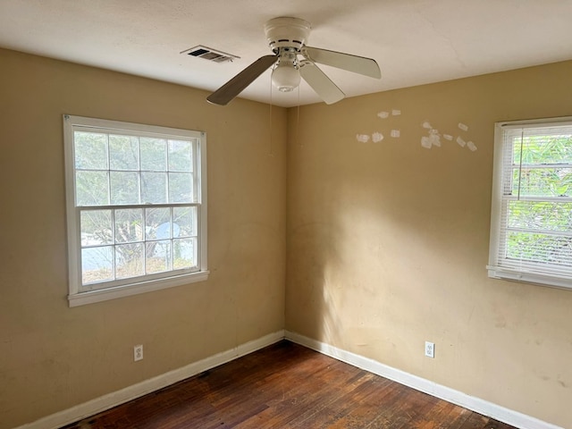 unfurnished room with dark wood-type flooring and ceiling fan