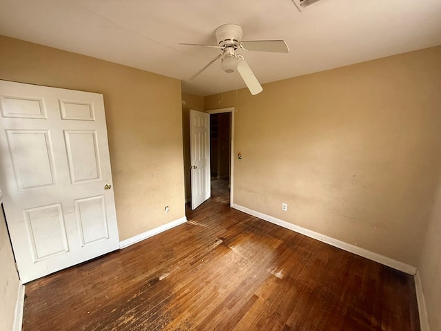 unfurnished bedroom with ceiling fan and dark hardwood / wood-style flooring