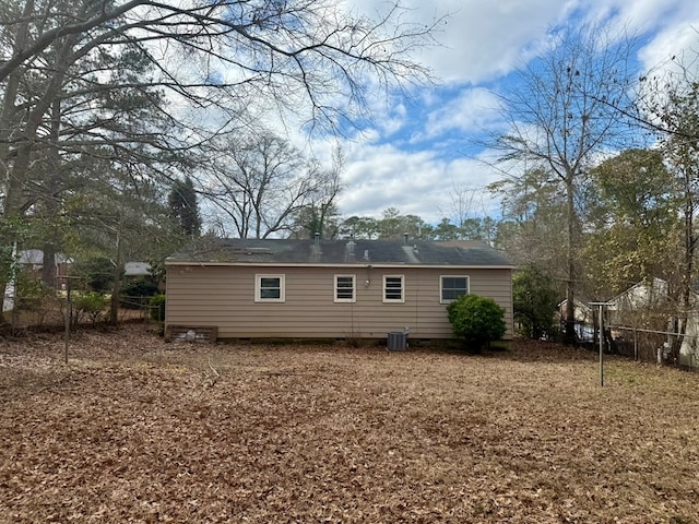 rear view of house featuring central AC