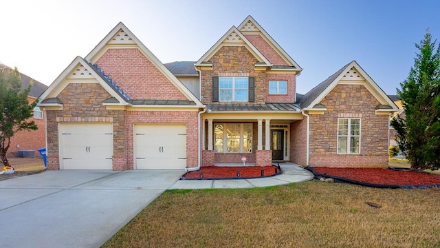 craftsman-style house featuring a garage, covered porch, central air condition unit, and a front yard