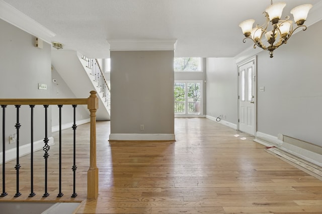 15635 US Highway 0027, Hamilton, GA 31811 - interior space featuring crown molding, stairs, light wood-style floors, baseboards, and a notable chandelier