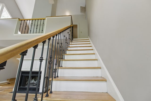 15635 US Highway 0027, Hamilton, GA 31811 - staircase featuring wood finished floors, a towering ceiling, and baseboards