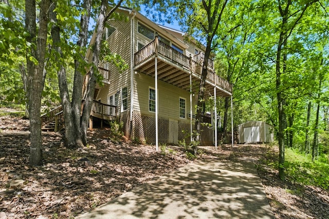 15635 US Highway 0027, Hamilton, GA 31811 - view of home's exterior featuring a storage shed, concrete driveway, a wooden deck, stairs, and an outdoor structure
