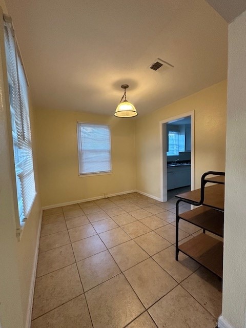 unfurnished dining area featuring light tile patterned floors and a healthy amount of sunlight