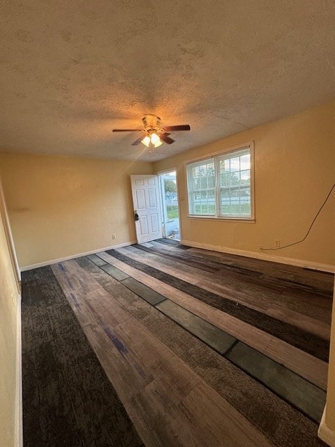 spare room with hardwood / wood-style floors, a textured ceiling, ceiling fan, and lofted ceiling