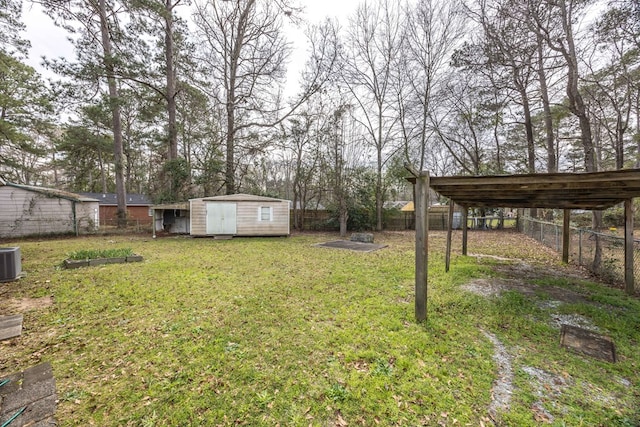 view of yard featuring a fenced backyard, an outdoor structure, and a shed