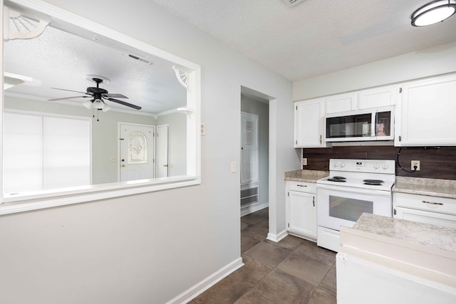 kitchen with visible vents, white cabinetry, light countertops, and white electric range