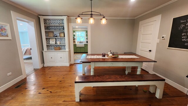 4232 Almond Rd, Fortson, GA 31808 - dining space with wood finished floors, crown molding, and baseboards