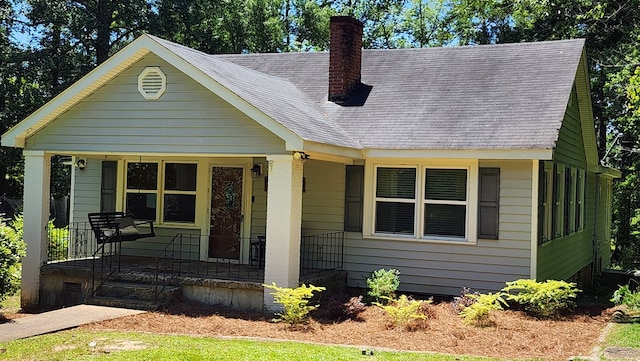 4232 Almond Rd, Fortson, GA 31808 - bungalow-style house with covered porch, a chimney, and a shingled roof
