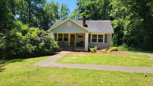 4232 Almond Rd, Fortson, GA 31808 - bungalow featuring covered porch, a chimney, and a front lawn