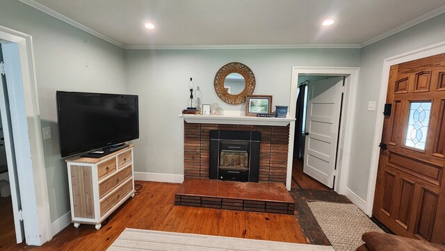 4232 Almond Rd, Fortson, GA 31808 - living room featuring baseboards, crown molding, wood finished floors, recessed lighting, and a brick fireplace