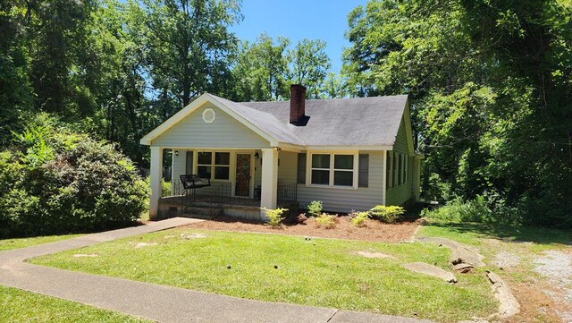 4232 Almond Rd, Fortson, GA 31808 - bungalow with covered porch, a front lawn, and a chimney
