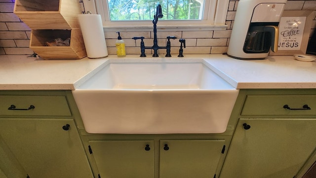 4232 Almond Rd, Fortson, GA 31808 - kitchen view of green cabinets, a sink, decorative backsplash, and light countertops