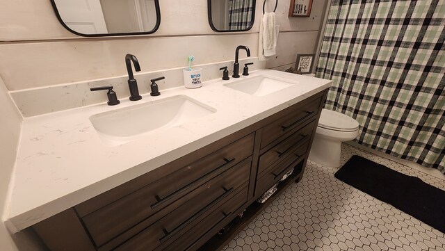 4232 Almond Rd, Fortson, GA 31808 - full bathroom with double vanity, toilet, and a shower with shower curtain