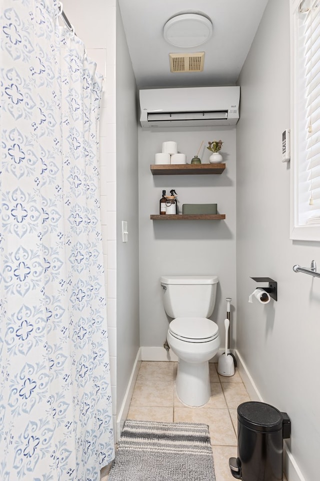 full bath featuring baseboards, visible vents, a wall unit AC, toilet, and tile patterned floors