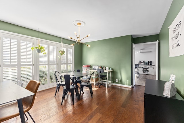 dining area with baseboards, a chandelier, and dark wood finished floors