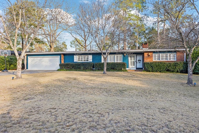 single story home featuring a garage, brick siding, and a chimney