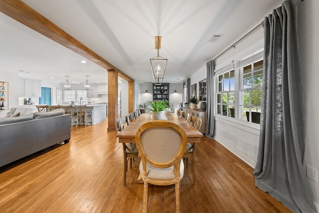 dining room with a chandelier, light wood finished floors, plenty of natural light, and recessed lighting