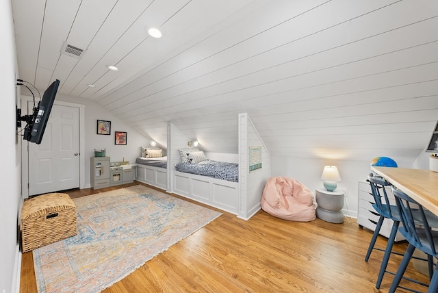 bedroom with light wood-type flooring, vaulted ceiling, and recessed lighting
