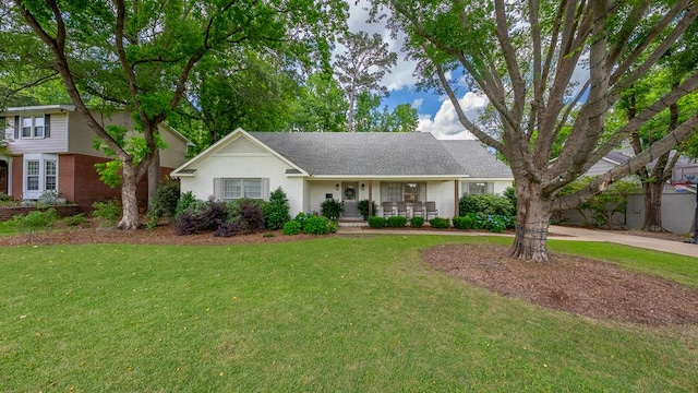 view of front of home with a front yard, brick siding, and a porch