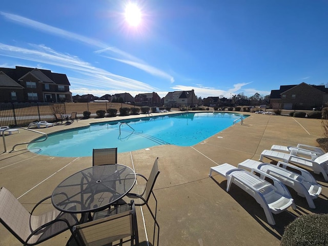 view of swimming pool with a patio area