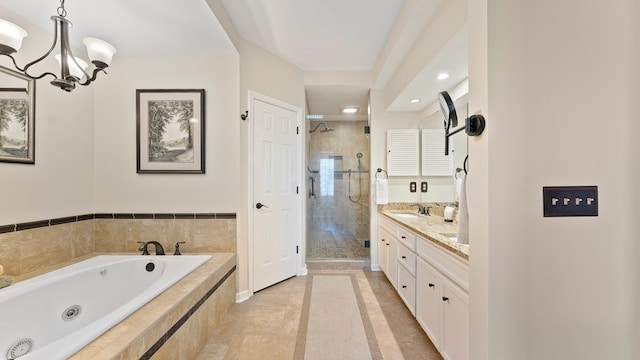 6359 Cape Cod Dr, Columbus, GA 31904 - bathroom featuring a stall shower, a jetted tub, double vanity, a chandelier, and recessed lighting