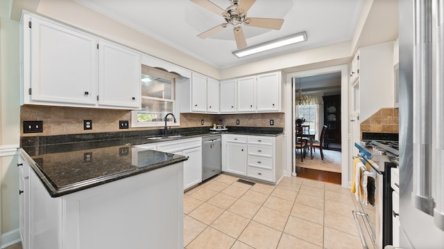 6359 Cape Cod Dr, Columbus, GA 31904 - kitchen with stainless steel appliances, plenty of natural light, white cabinetry, a peninsula, and crown molding