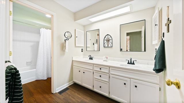 6359 Cape Cod Dr, Columbus, GA 31904 - bathroom with double vanity, wood finished floors, and shower / tub combo with curtain