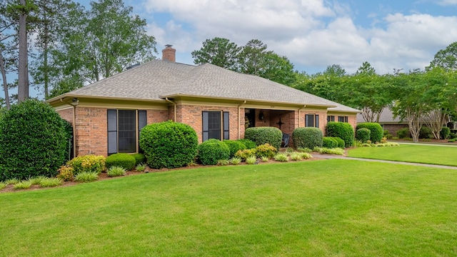 6359 Cape Cod Dr, Columbus, GA 31904 - view of front of house featuring a chimney, brick siding, a front lawn, and a shingled roof