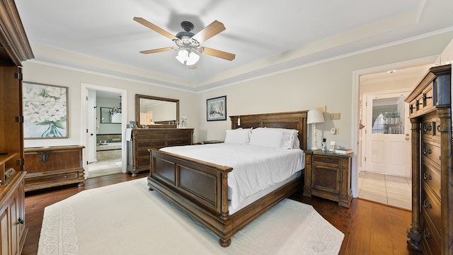 6359 Cape Cod Dr, Columbus, GA 31904 - bedroom featuring dark wood-style flooring, a raised ceiling, ornamental molding, a ceiling fan, and connected bathroom