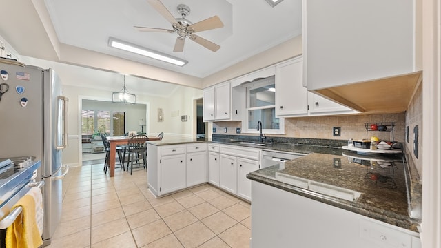 6359 Cape Cod Dr, Columbus, GA 31904 - kitchen with appliances with stainless steel finishes, a peninsula, a ceiling fan, white cabinets, and ornamental molding