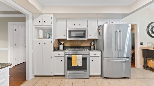 6359 Cape Cod Dr, Columbus, GA 31904 - kitchen featuring appliances with stainless steel finishes, dark countertops, white cabinets, crown molding, and tasteful backsplash