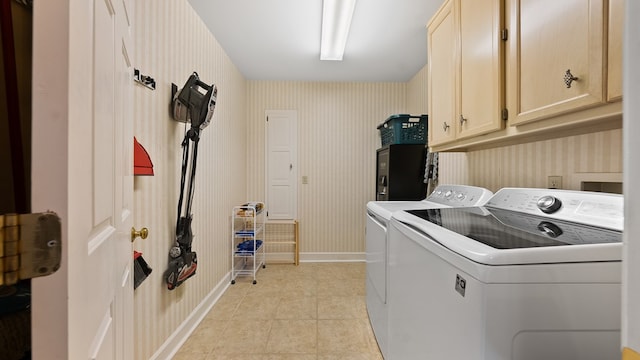 6359 Cape Cod Dr, Columbus, GA 31904 - washroom featuring cabinet space, washer and clothes dryer, wallpapered walls, and light tile patterned floors