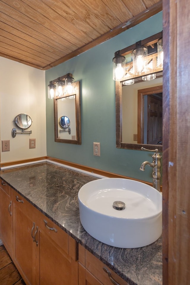 bathroom with vanity, wood-type flooring, and wood ceiling