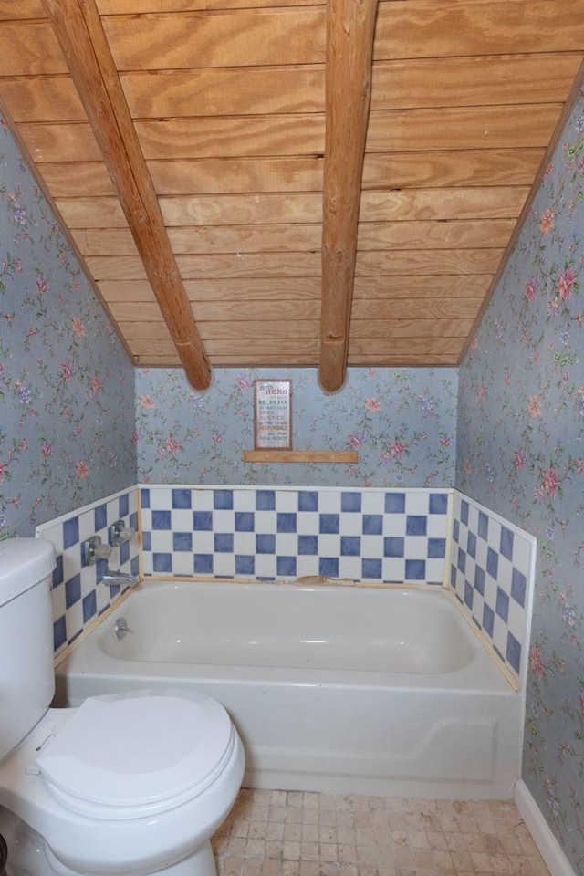 bathroom with toilet, wooden ceiling, and a bath