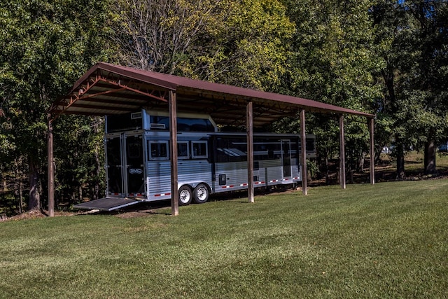 view of vehicle parking with a yard and a carport