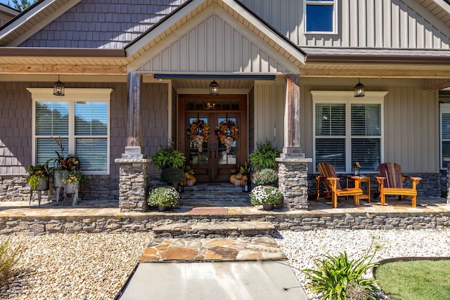 entrance to property with french doors and a porch