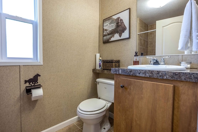 bathroom with vanity, tile patterned floors, a textured ceiling, and toilet