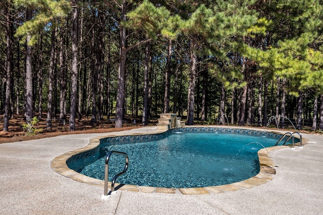 view of swimming pool with pool water feature and a patio