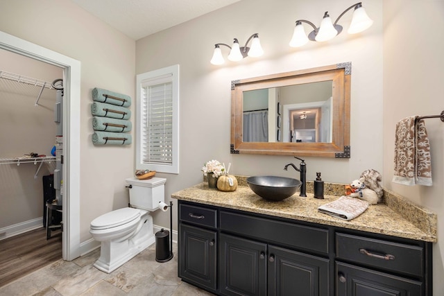 bathroom featuring wood-type flooring, vanity, and toilet