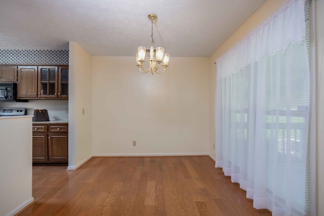 4608 Mayo Dr, Columbus, GA 31909 - unfurnished dining area featuring light wood-style flooring and a chandelier