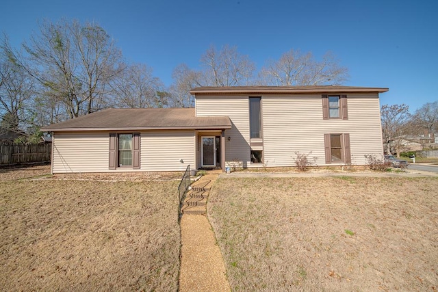 back of house featuring fence and a yard