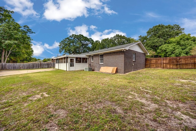 2245 Gennings Ct, Columbus, GA 31907 - rear view of house featuring a sunroom, a fenced backyard, and brick siding