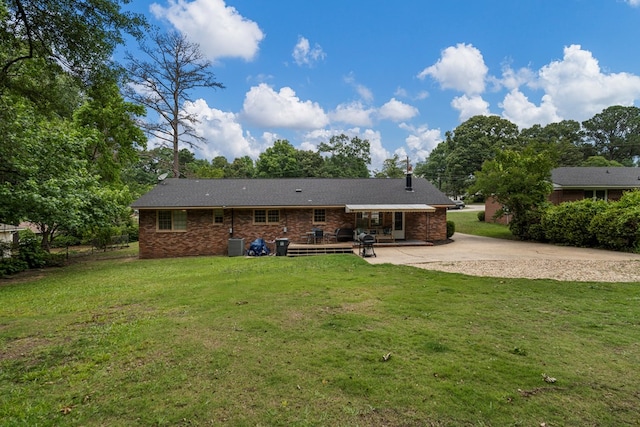 1903 Ashley Dr, Phenix City, AL 36867 - rear view of property featuring a lawn, concrete driveway, brick siding, and a patio area