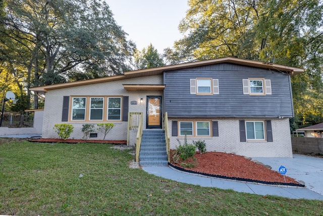 tri-level home with a front lawn