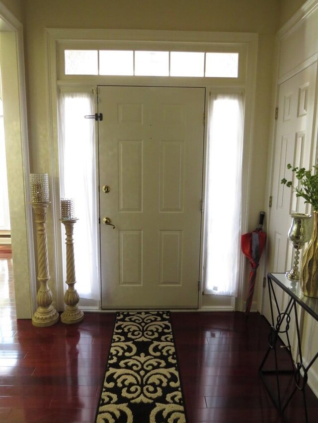 living room featuring a ceiling fan, a tiled fireplace, light colored carpet, ornamental molding, and visible vents