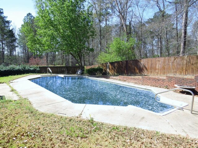 view of swimming pool with a fenced backyard, a fenced in pool, and a patio
