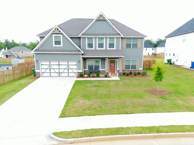 craftsman-style house featuring a front yard and a garage