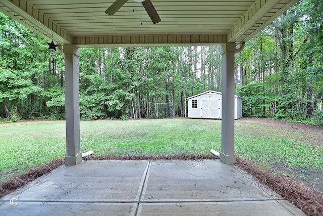 72W Teddy Bear Ln, Waverly Hall, GA 31831 - view of grassy yard featuring ceiling fan, a storage shed, a patio area, and an outdoor structure